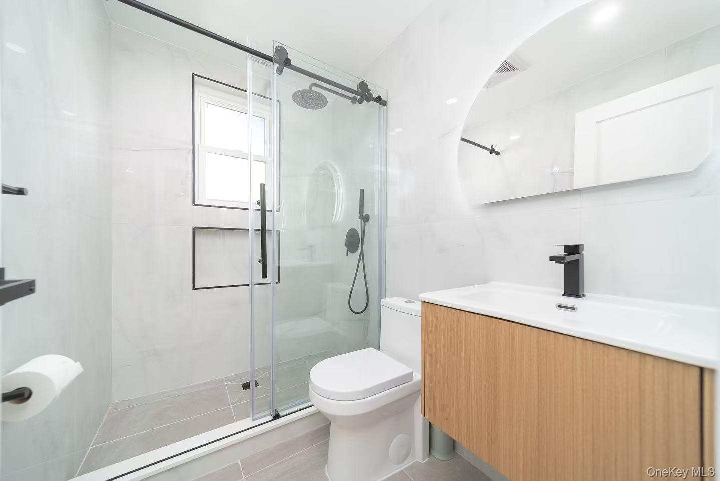 7-24 128th Street Queens, NY 11356 - Photo 11 of 31 Bathroom featuring vanity, a shower stall, and light tile patterned floors