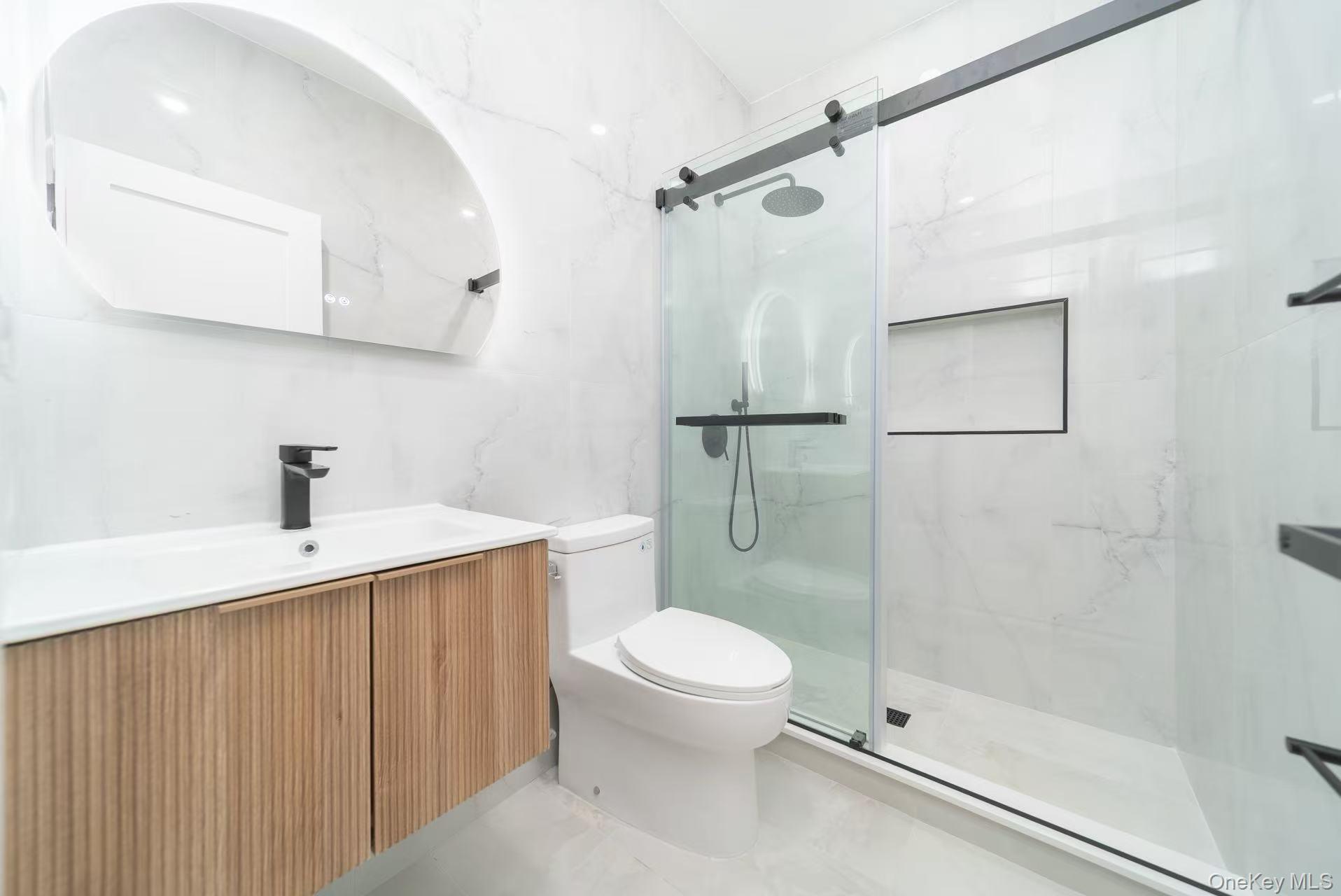 7-24 128th Street Queens, NY 11356 - Photo 13 of 31 Full bathroom featuring vanity and a marble finish shower