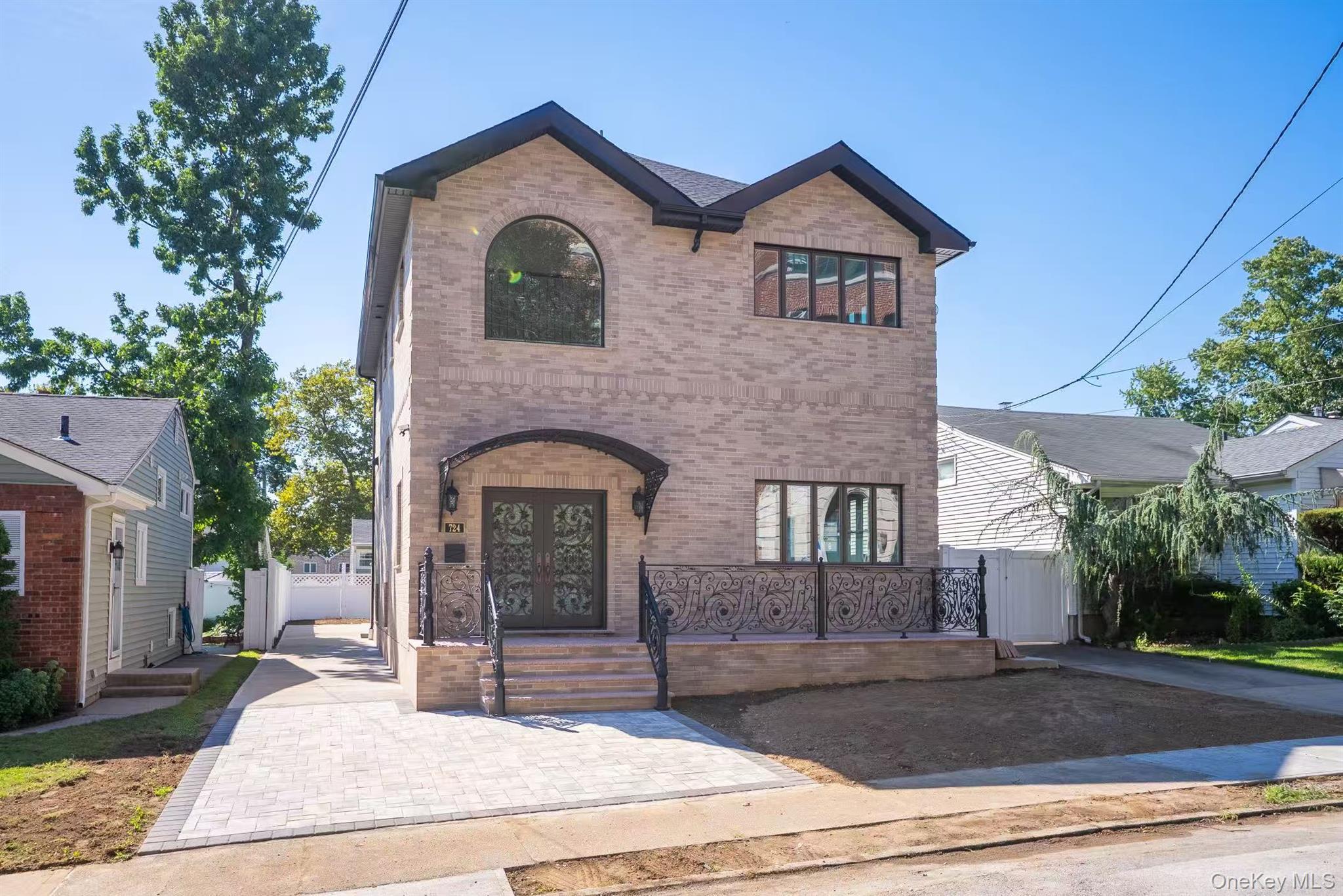 7-24 128th Street Queens, NY 11356 - Photo 2 of 31 View of front of home with brick siding, french doors, and a gate