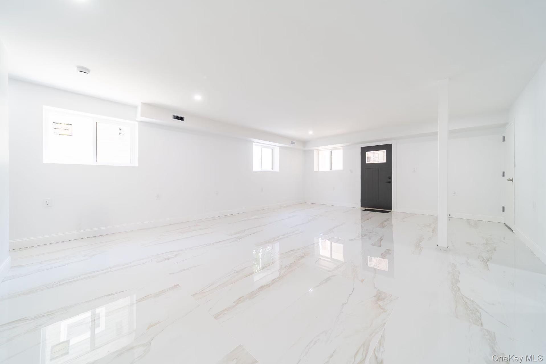 7-24 128th Street Queens, NY 11356 - Photo 21 of 31 Spare room featuring plenty of natural light, recessed lighting, and light marble finish flooring