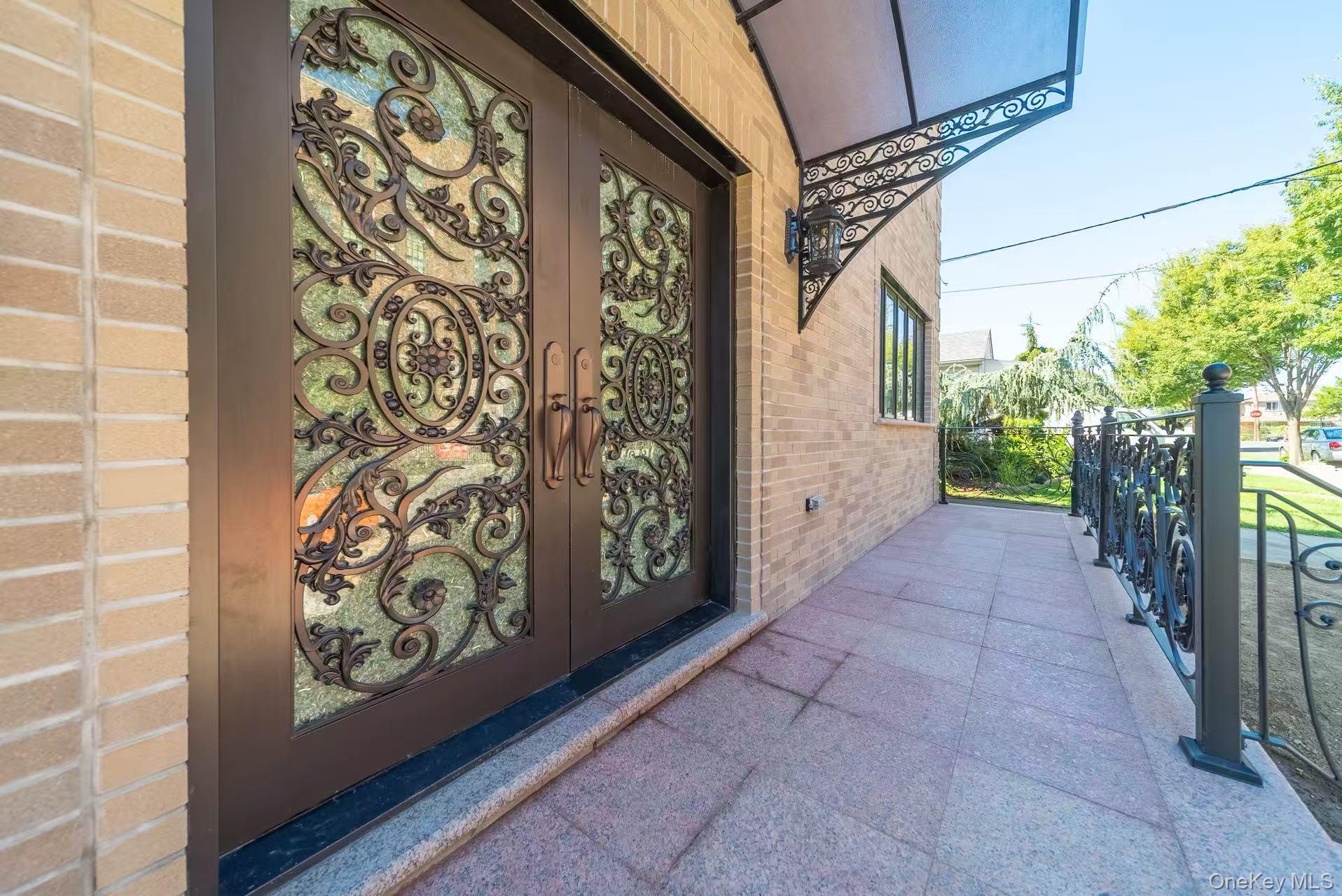 7-24 128th Street Queens, NY 11356 - Photo 22 of 31 View of exterior entry featuring brick siding and french doors