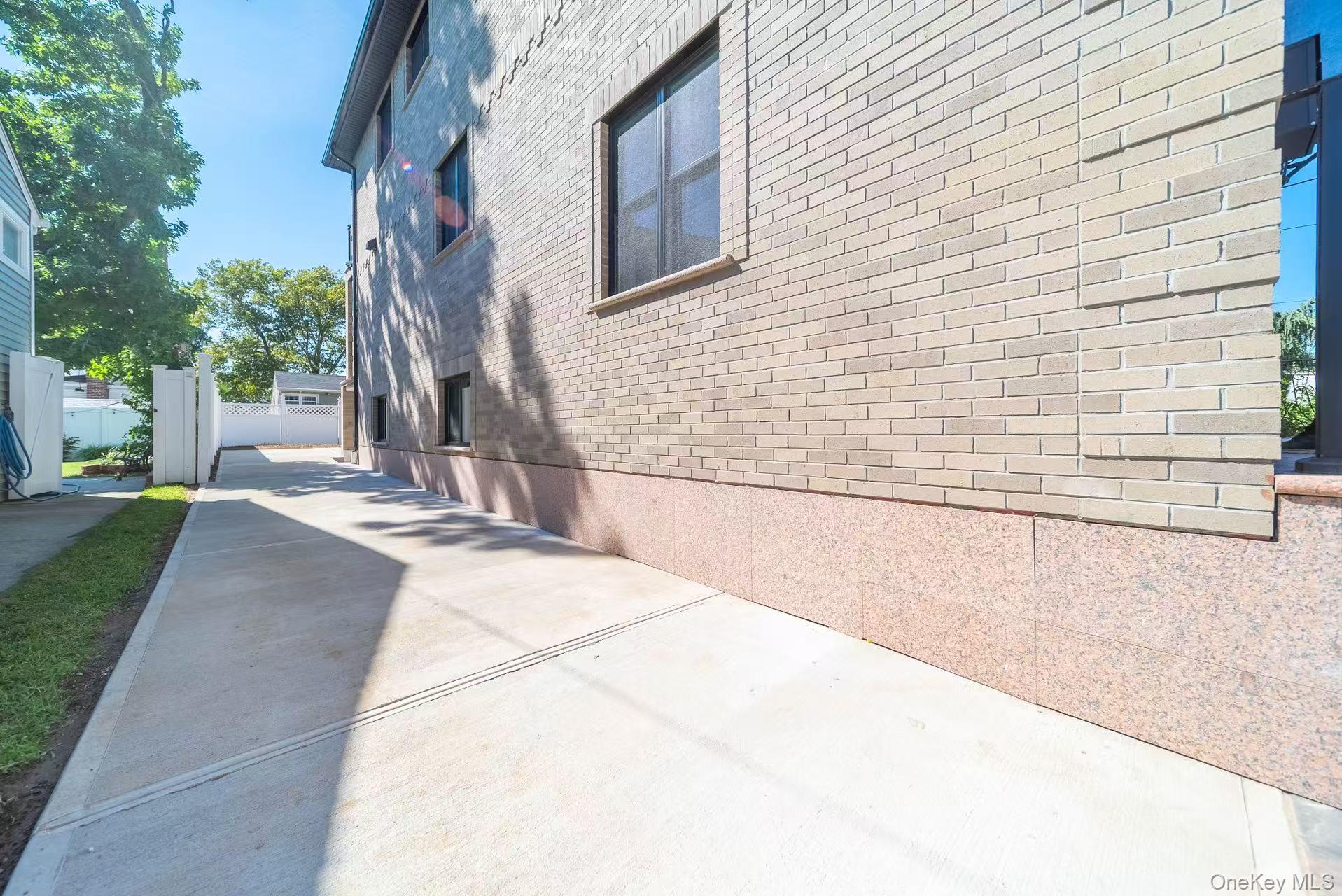 7-24 128th Street Queens, NY 11356 - Photo 25 of 31 View of home's exterior with brick siding