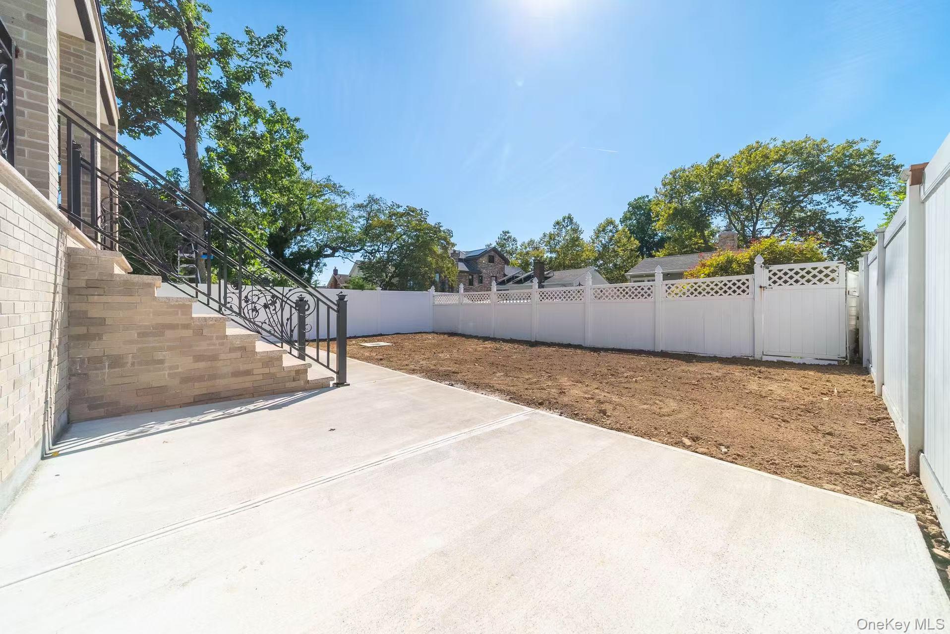7-24 128th Street Queens, NY 11356 - Photo 27 of 31 Fenced backyard featuring stairway and a patio