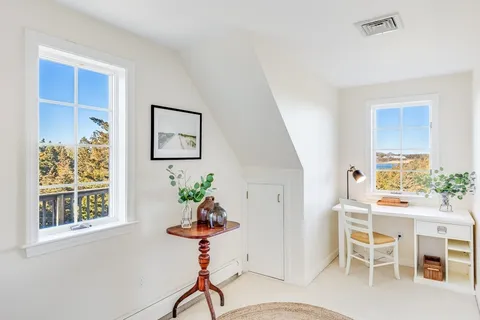 a dining room with furniture a potted plant and a chandelier