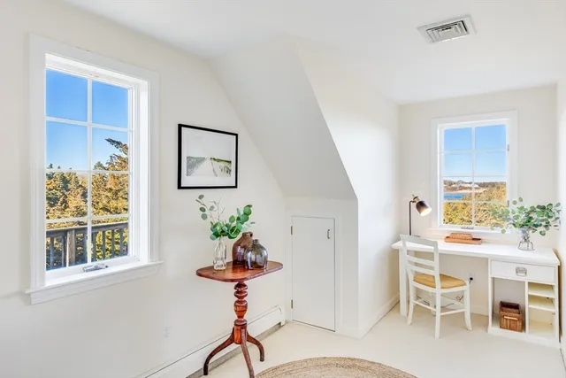 a dining room with furniture a potted plant and a chandelier