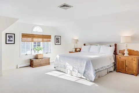 a bedroom with bed and window