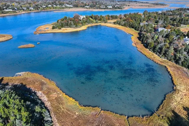 a view of a house with a deck and a yard