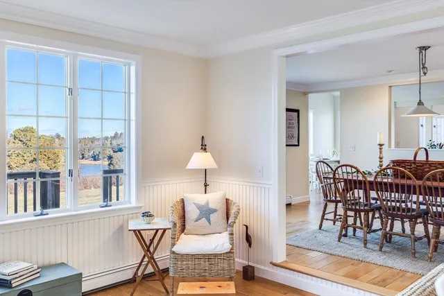 a living room with furniture a wooden floor and a chandelier