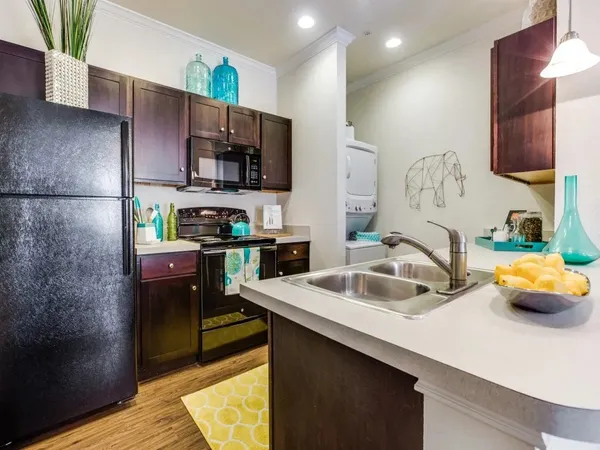 a kitchen with a sink and a refrigerator