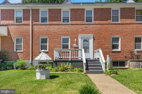 a front view of a house with garden and porch