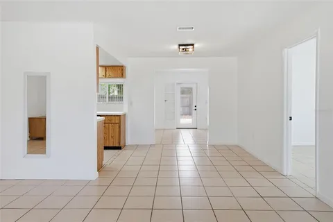 a view of a livingroom with wooden floor and a refrigerator
