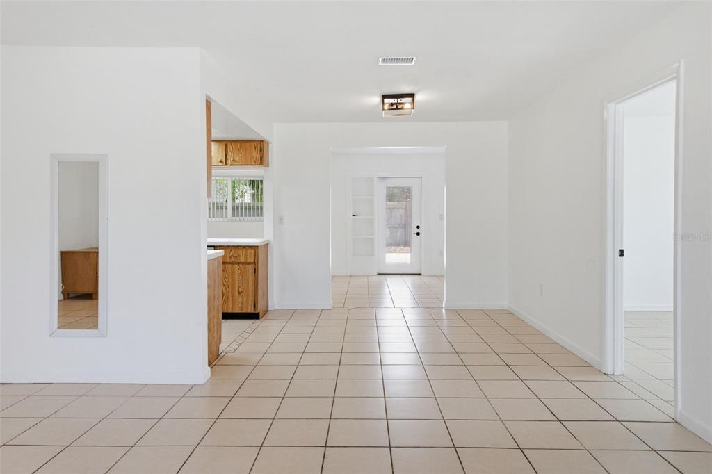 4536 Webber Street Sarasota, FL 34232 - Photo 7 of 45 a view of a livingroom with wooden floor and a refrigerator