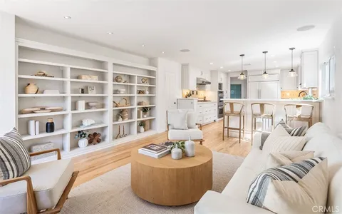 a living room with furniture and a book shelf