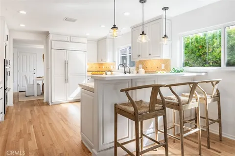 a kitchen with stainless steel appliances granite countertop a kitchen island a stove a cabinets and a sink