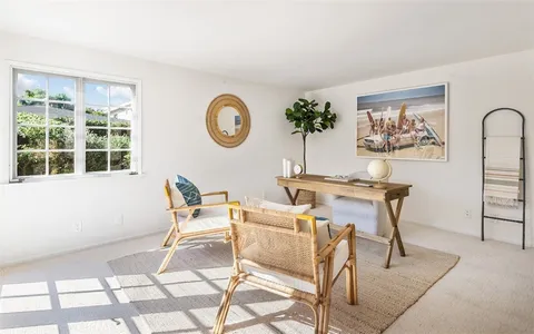 a work room with furniture and a window