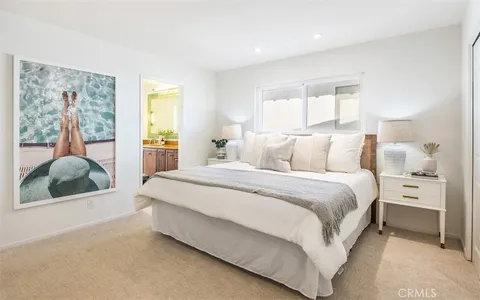 a bedroom with a large bed and a window