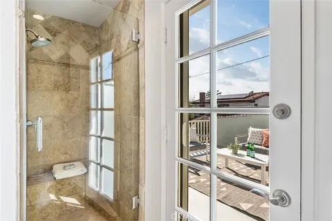 a bathroom with a glass shower door and mirror