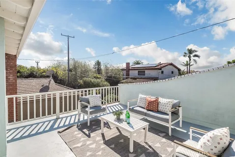 a bedroom with a bed and painting on the wall
