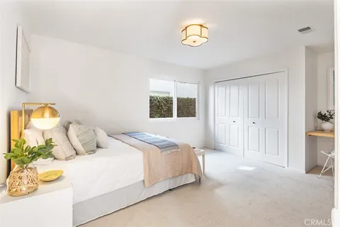 a spacious bedroom with a bed and a window