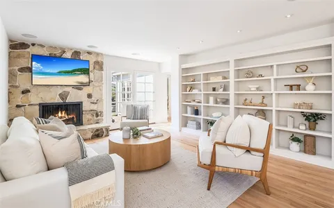 a living room with furniture and a book shelf