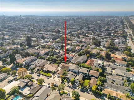 an aerial view of a house with a yard and sitting area
