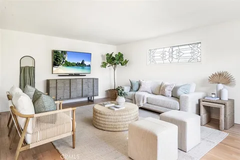 a living room with furniture and a potted plant