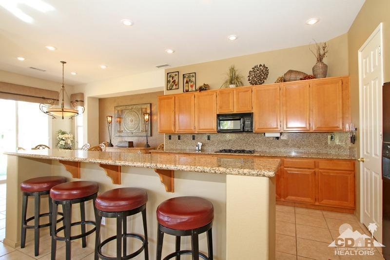 7 Wimbledon Circle Rancho Mirage, CA 92270 - Photo 11 of 46 a large kitchen with lots of counter space and furniture