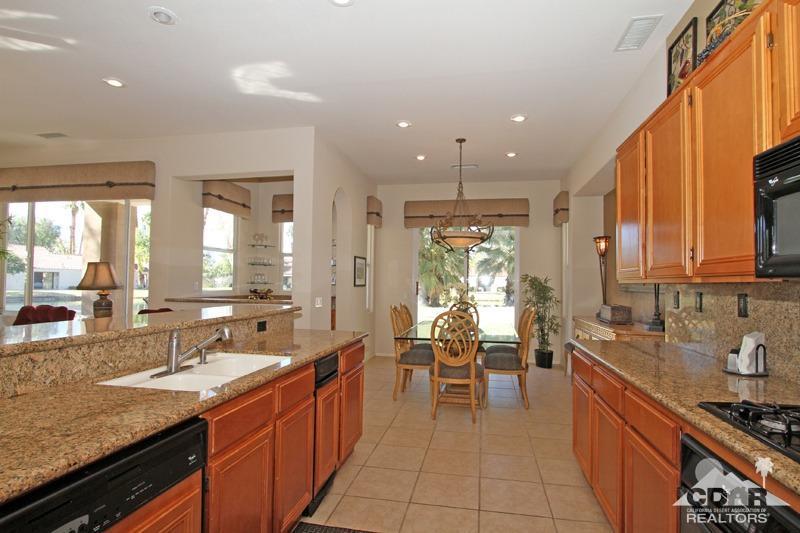 7 Wimbledon Circle Rancho Mirage, CA 92270 - Photo 12 of 46 a large kitchen with kitchen island granite countertop a large window