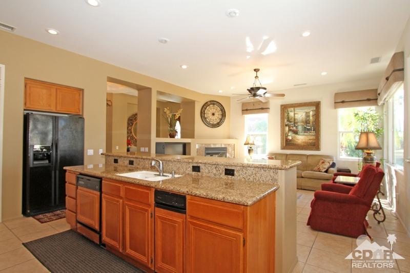 7 Wimbledon Circle Rancho Mirage, CA 92270 - Photo 13 of 46 a large kitchen with kitchen island granite countertop a sink and dishwasher wooden cabinets with stainless steel appliances