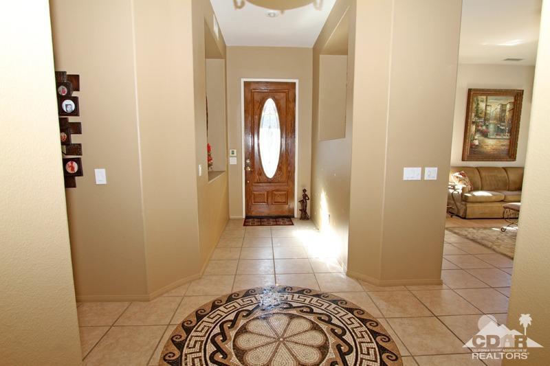 7 Wimbledon Circle Rancho Mirage, CA 92270 - Photo 17 of 46 a view of a hallway with wooden floor and a bathroom