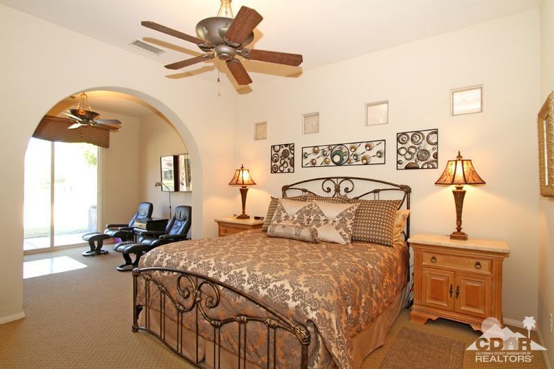 7 Wimbledon Circle Rancho Mirage, CA 92270 - Photo 19 of 46 a bedroom with a bed and wooden floor