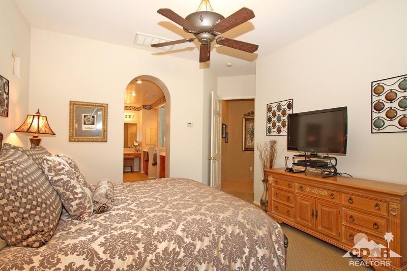 7 Wimbledon Circle Rancho Mirage, CA 92270 - Photo 22 of 46 a bedroom with a bed and a flat screen tv