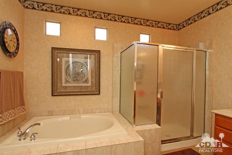 7 Wimbledon Circle Rancho Mirage, CA 92270 - Photo 24 of 46 a bathroom with a bathtub and a shower