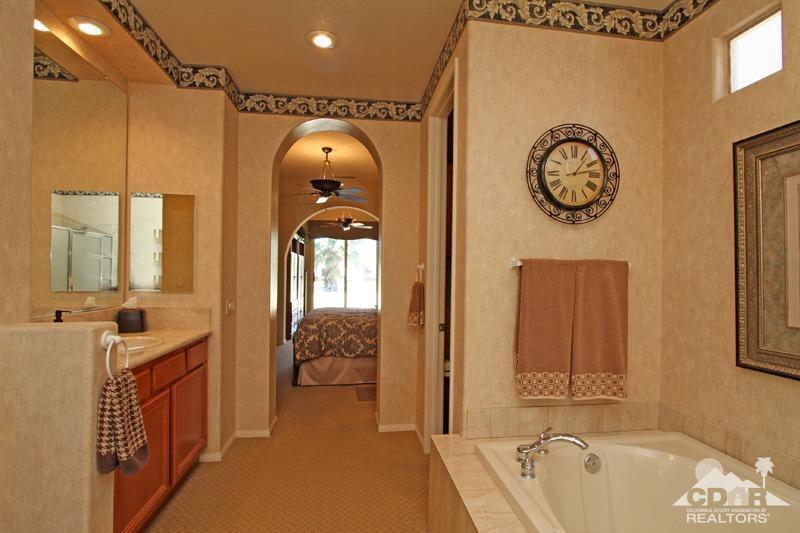 7 Wimbledon Circle Rancho Mirage, CA 92270 - Photo 25 of 46 a spacious bathroom with a tub and a large mirror