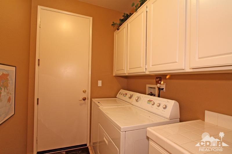 7 Wimbledon Circle Rancho Mirage, CA 92270 - Photo 32 of 46 a utility room with dryer and washer