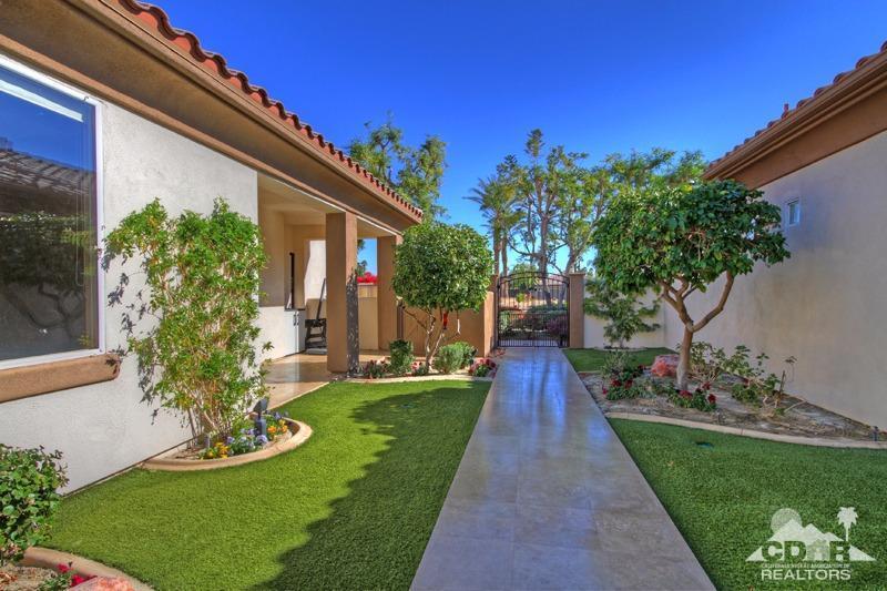 7 Wimbledon Circle Rancho Mirage, CA 92270 - Photo 37 of 46 a front view of a house with a yard