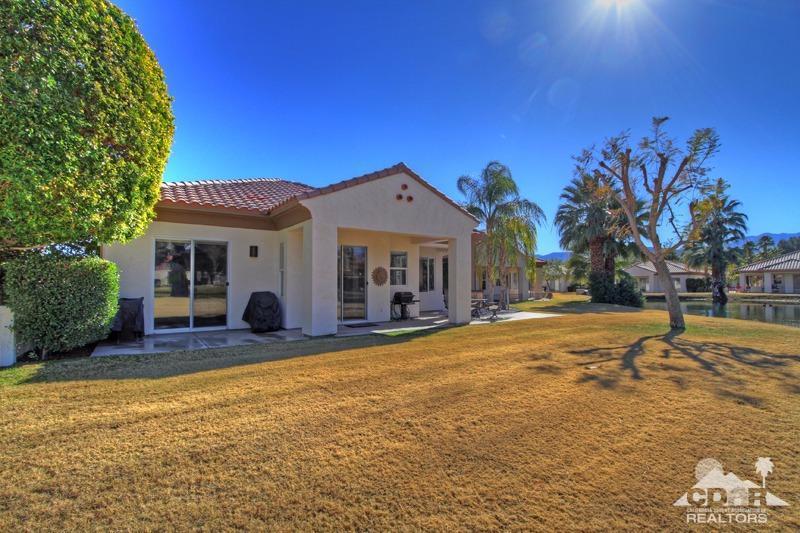 7 Wimbledon Circle Rancho Mirage, CA 92270 - Photo 45 of 46 a view of a house with swimming pool and a yard
