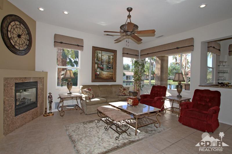 7 Wimbledon Circle Rancho Mirage, CA 92270 - Photo 7 of 46 a living room with furniture a fireplace and a large window