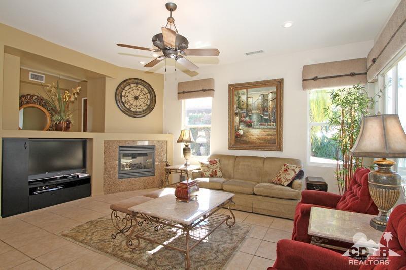 7 Wimbledon Circle Rancho Mirage, CA 92270 - Photo 8 of 46 a living room with furniture and a fireplace