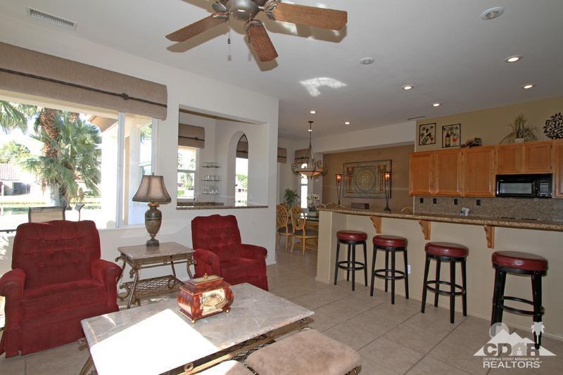 7 Wimbledon Circle Rancho Mirage, CA 92270 - Photo 9 of 46 a living room with stainless steel appliances kitchen island granite countertop furniture and a large window