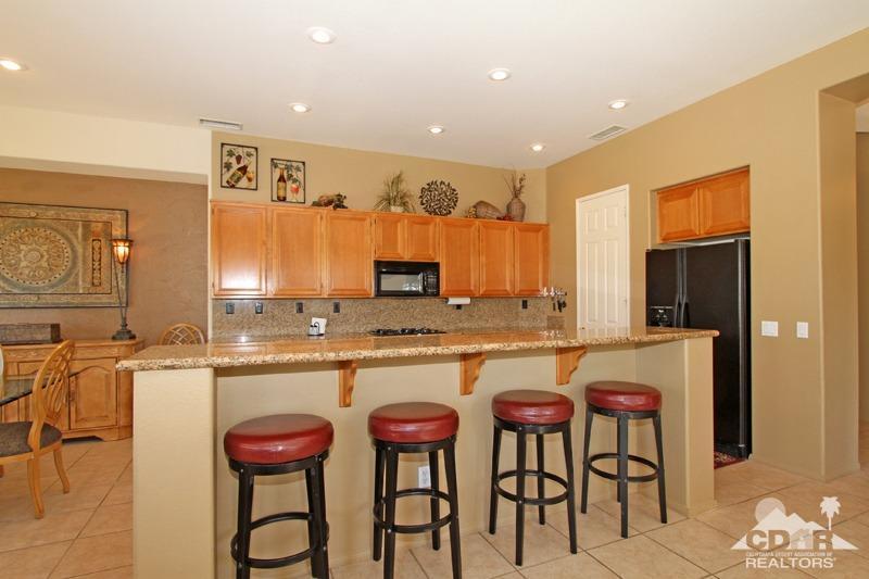 7 Wimbledon Circle Rancho Mirage, CA 92270 - Photo 10 of 46 a kitchen with a table and chairs in it