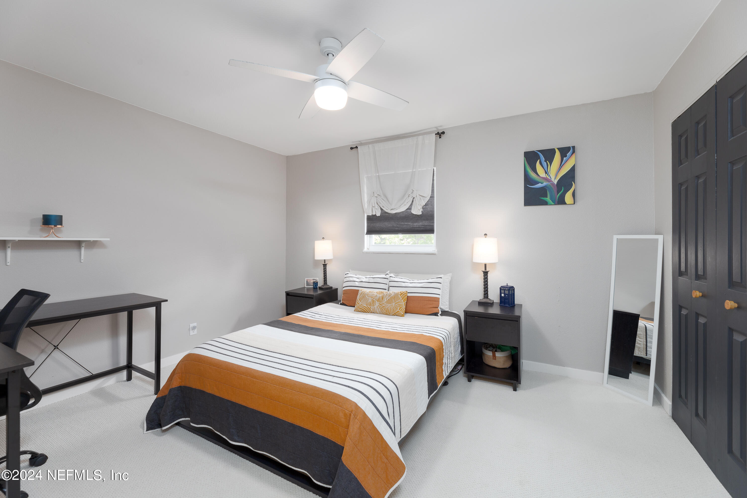 824 Cavalla Road Atlantic Beach, FL 32233 - Photo 13 of 18 a bedroom with a bed a table and painting on the wall
