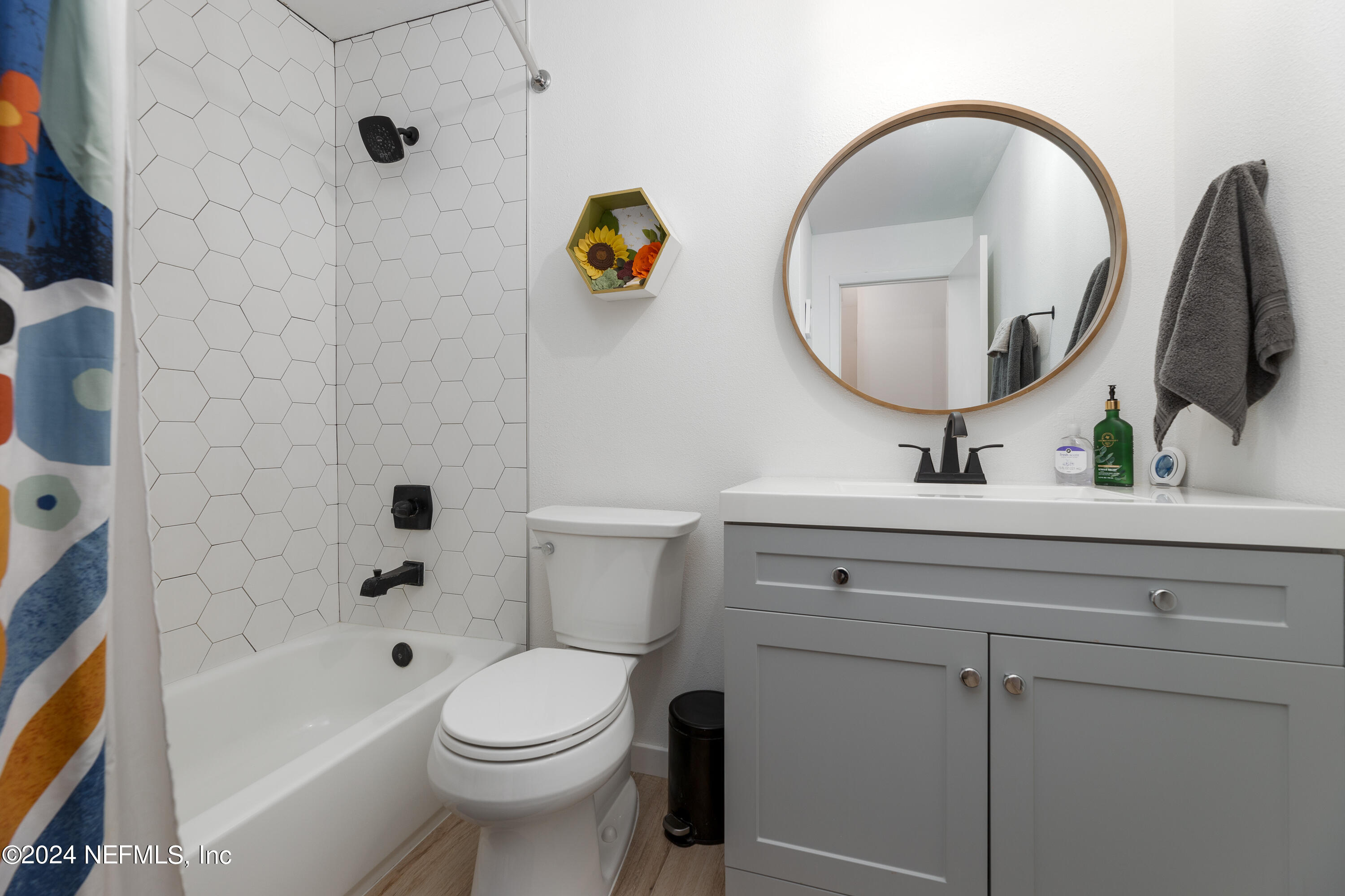 824 Cavalla Road Atlantic Beach, FL 32233 - Photo 15 of 18 a bathroom with a toilet sink vanity tub and mirror
