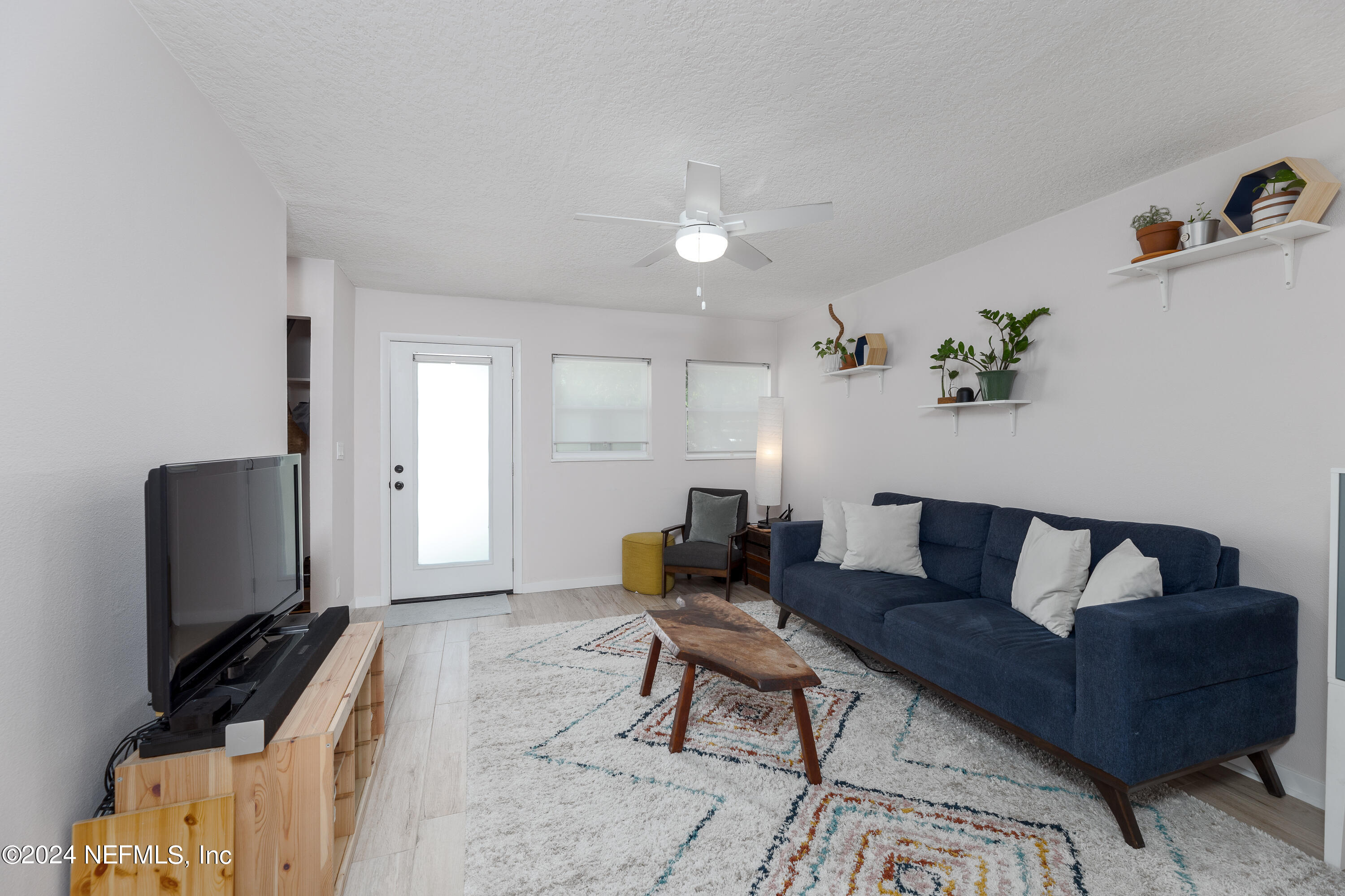 824 Cavalla Road Atlantic Beach, FL 32233 - Photo 3 of 18 a living room with furniture and a flat screen tv