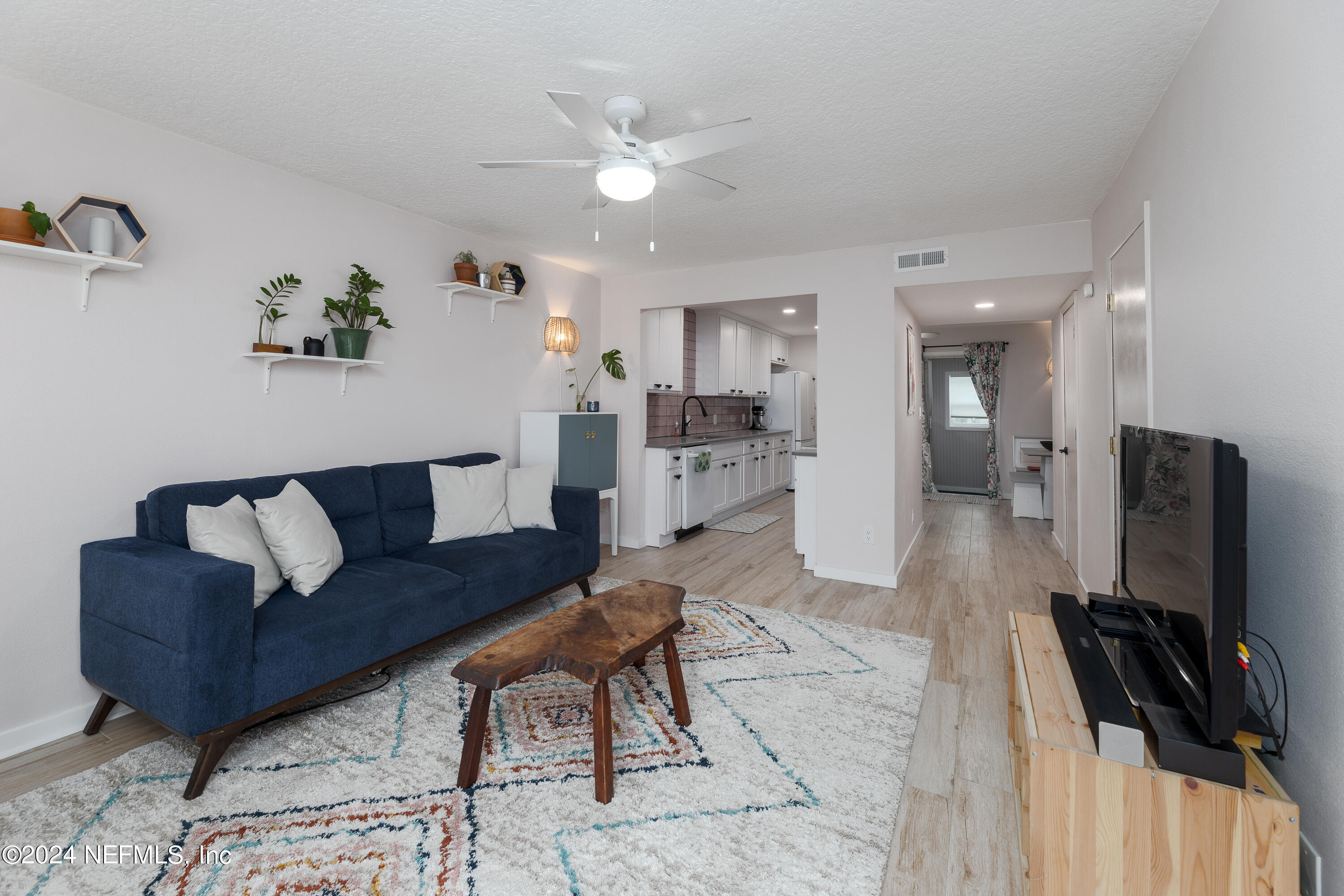 824 Cavalla Road Atlantic Beach, FL 32233 - Photo 5 of 18 a living room with furniture and a flat screen tv