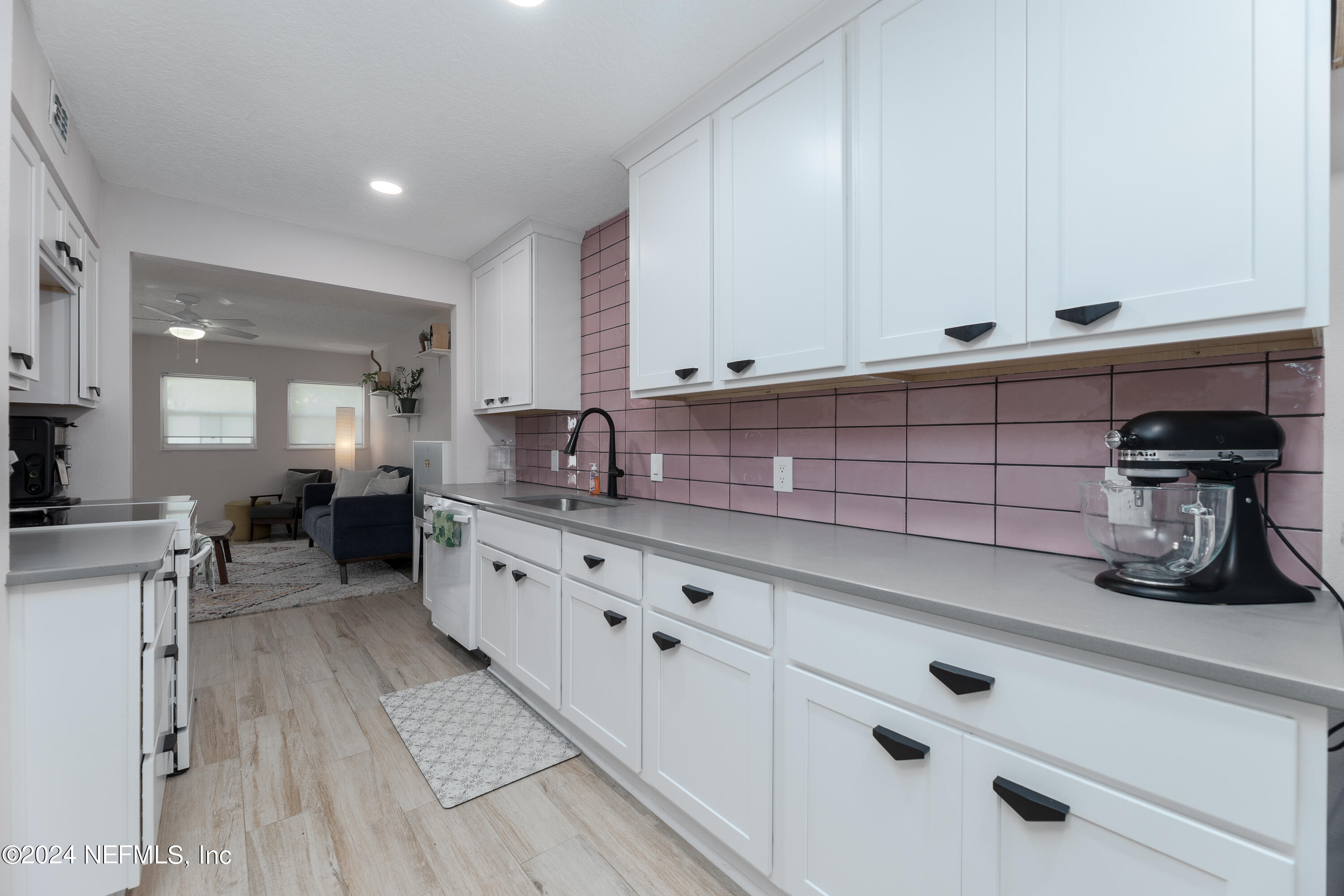 824 Cavalla Road Atlantic Beach, FL 32233 - Photo 9 of 18 a kitchen with granite countertop white cabinets and sink