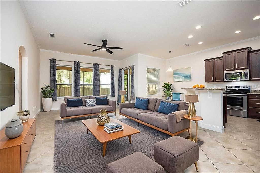 8216 Northwest 54th Street Gainesville, FL 32653 - Photo 22 of 58 a living room with furniture kitchen view and a flat screen tv