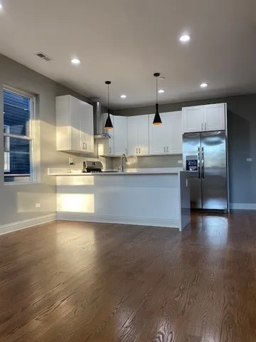 a large kitchen with stainless steel appliances lots of counter top space and cabinets