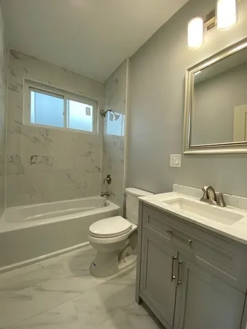a bathroom with a sink a toilet and a bathtub