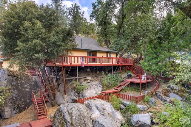 a backyard of a house with yard table and chairs